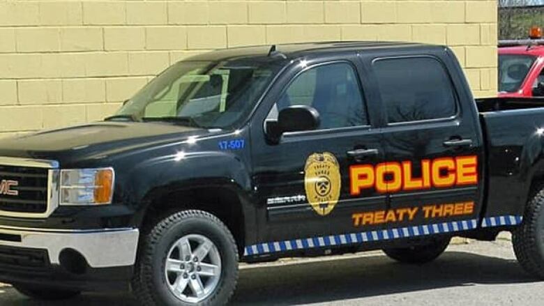 A black pick-up truck that says Police Treaty Three.