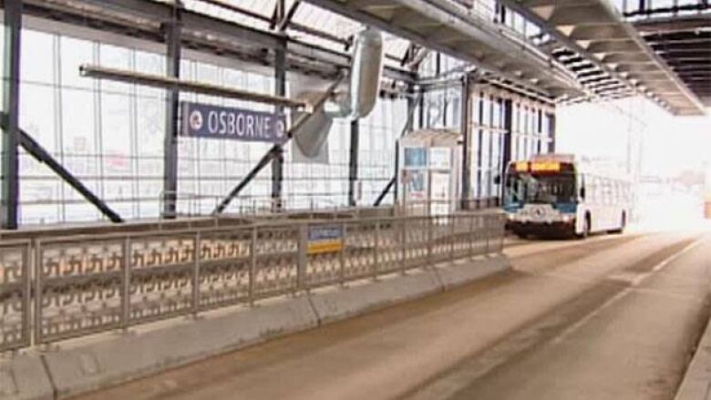 A bus enters a transit station corridor