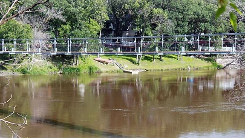 A pedestrian bridge over a river.