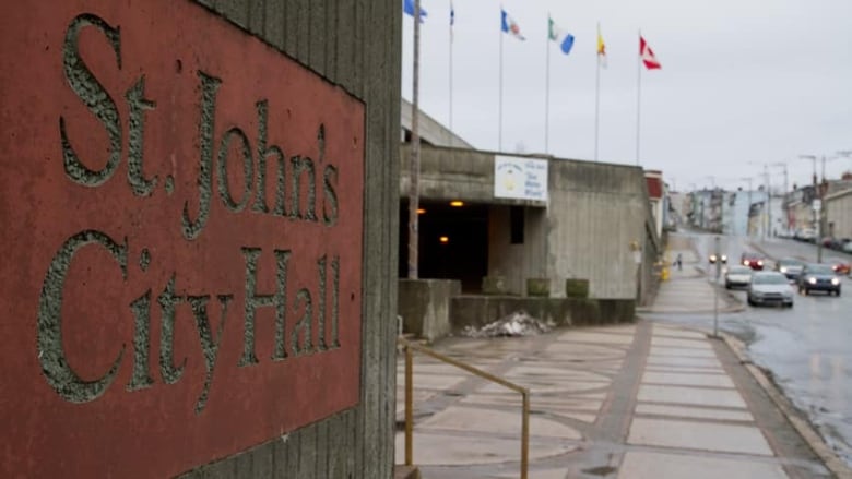 A sign on a building reads St. John's City Hall.