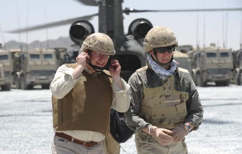 Prime Minister Stephen Harper and Defence Minister Peter MacKay visit Canadian soldiers at a forward operating base near Sperwan Ghar, Afghanistan, on May 30, 2011. (Sean Kilpatrick/CP)