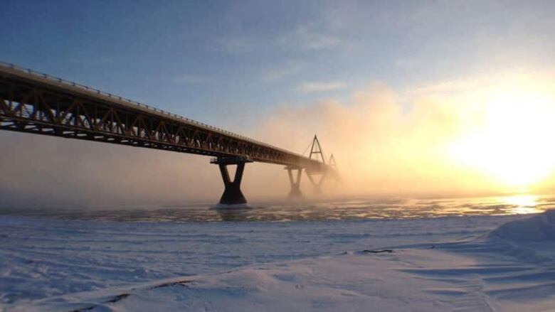 Mist partially obscures the Deh Cho Bridge.