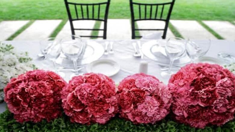 Wedding flowers on a long dining table.