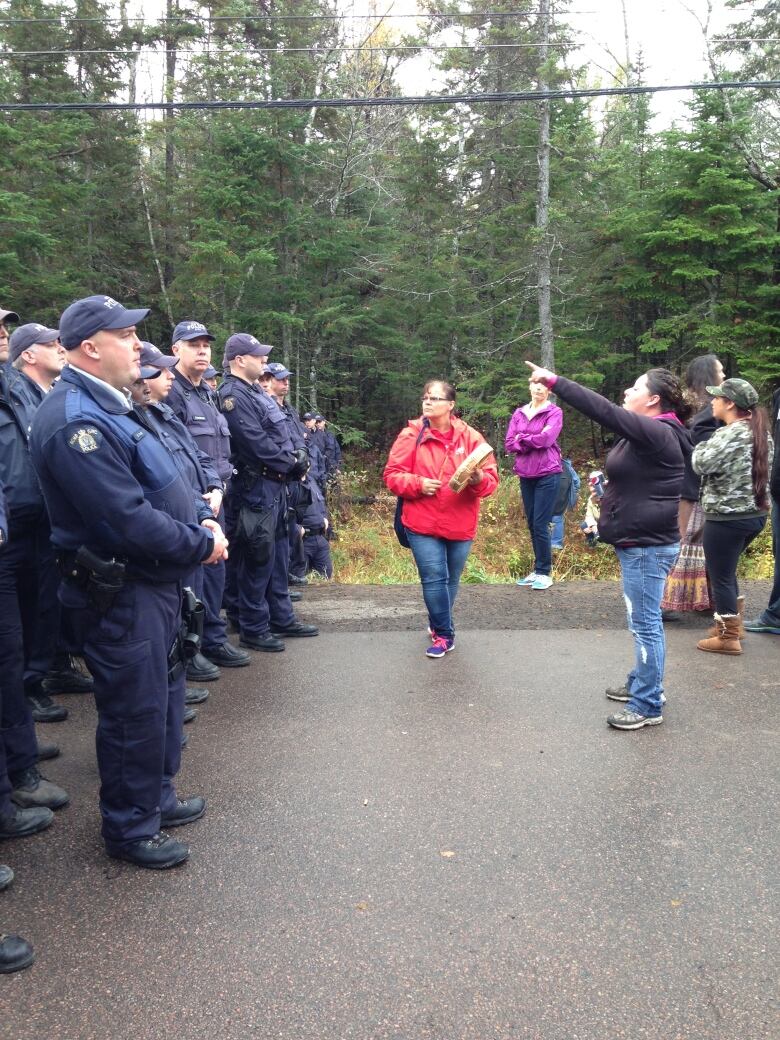 RCMP officers on the left, shale gas opponents on the right.