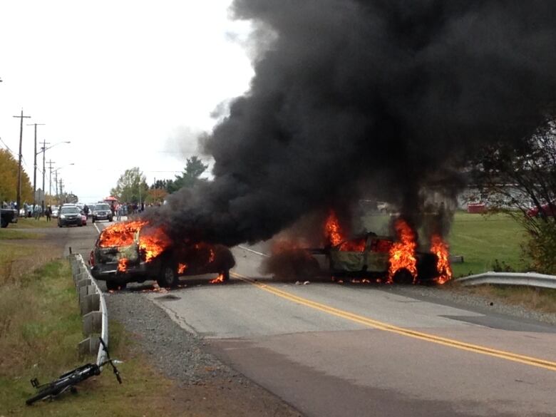 RCMP cruisers a blaze at the site of the 2013 clash.