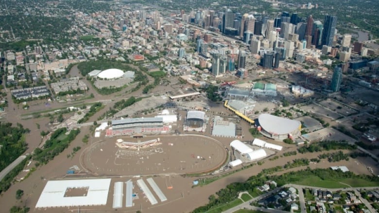 A aerial photo of central calgary shows deep brown water covering the Stampede grounds and neighbourhoods.