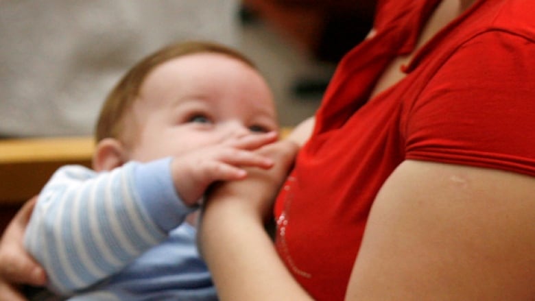 An image of a person breastfeeding a baby.