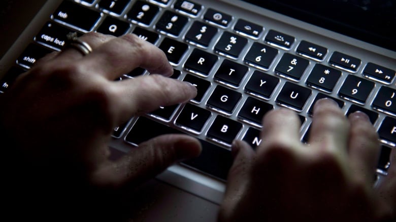 Hands are seen typing on a keyboard