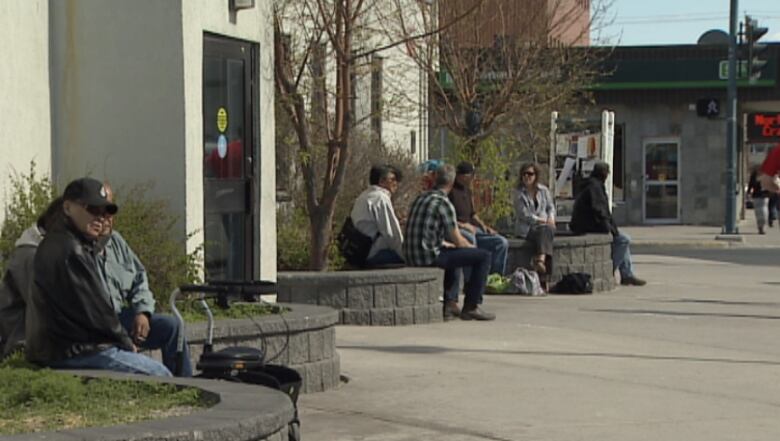 People sit on planters outside Yellowknife post office