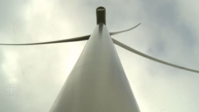 A view of one of the wind turbines, looking straight up from the ground.