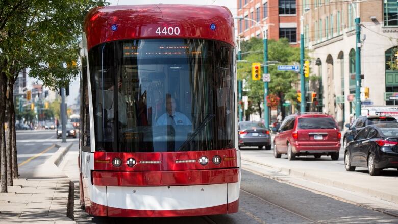 Red streetcar on Spadina Avenue.