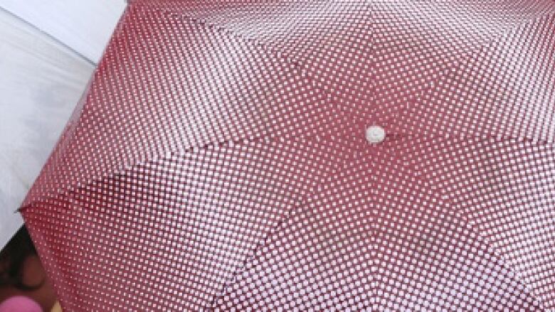 Closeup of top of an open red umbrella.