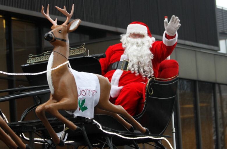 Santa sitting in his sleigh.