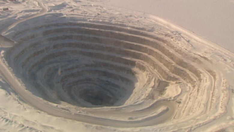 a deep pit, lots of circles in the sand.