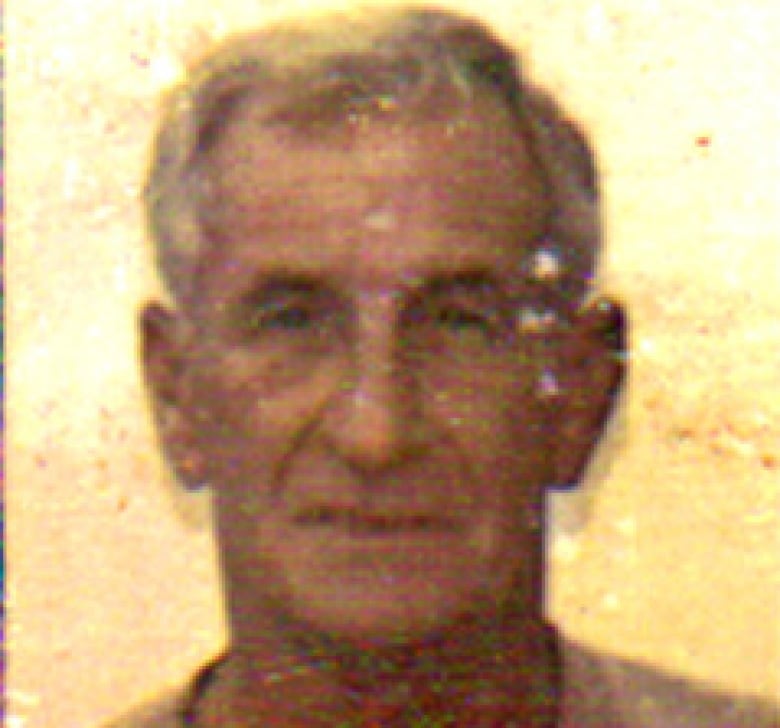 A mugshot of a white man with grey hair.