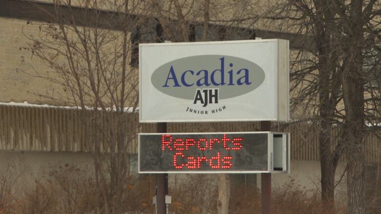 A sign outside a school says Acadia Junior High.