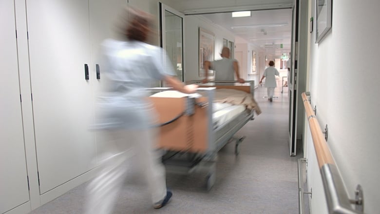 blur image of a doctors pushing a patient in a stretcher