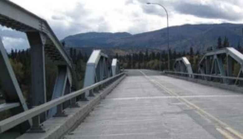 Looking across a two-lane highway bridge.