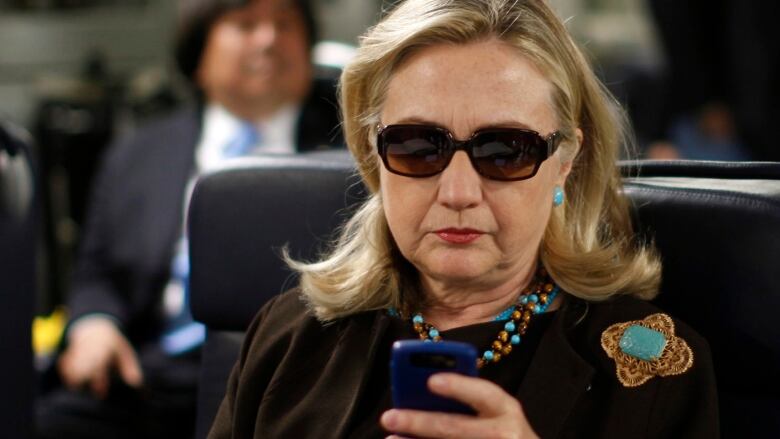 Hilary Clinton seen holding her Blackberry