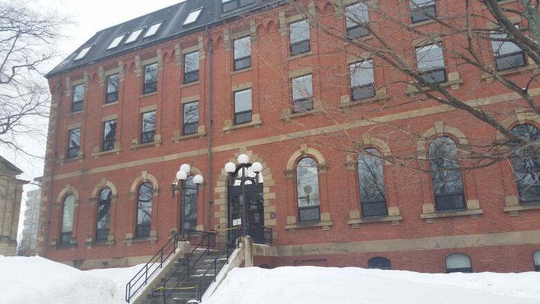 A four-story brick building, the Coles Building in Charlottetown in winter.