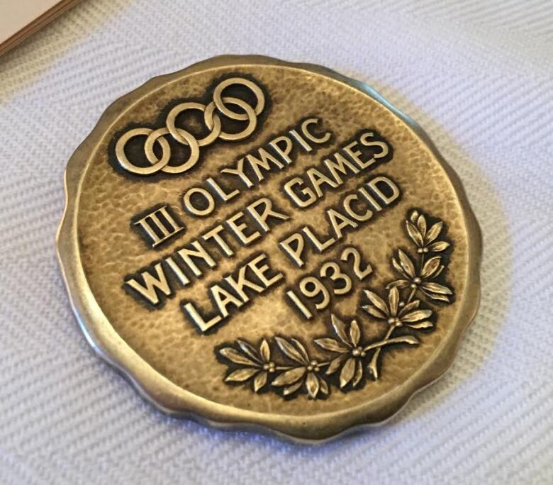 A gold medal on a table that reads 