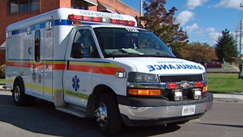 A white ambulance with an Essex-Windsor EMS logo on the side. 