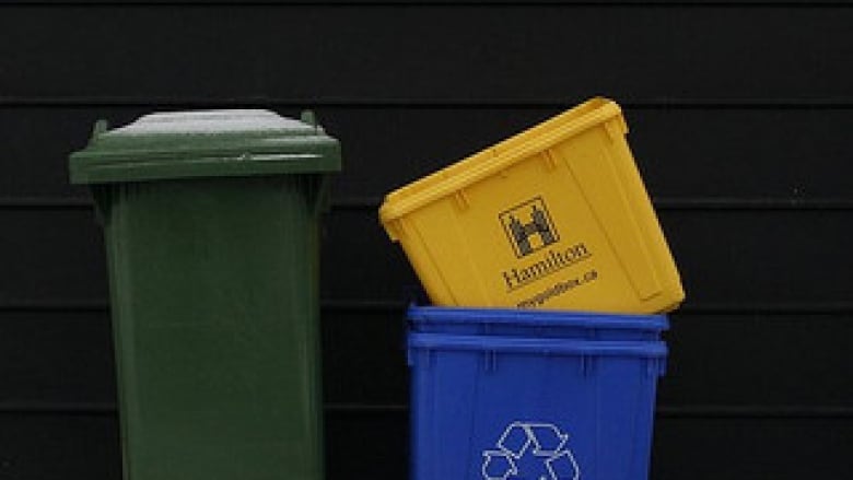 A picture of garbage bin and recycling boxes