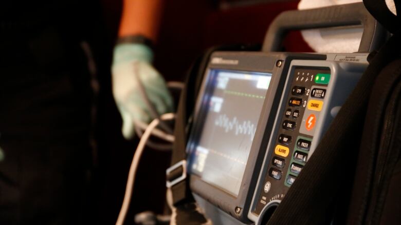 A heart rate monitor displays a heart rate.