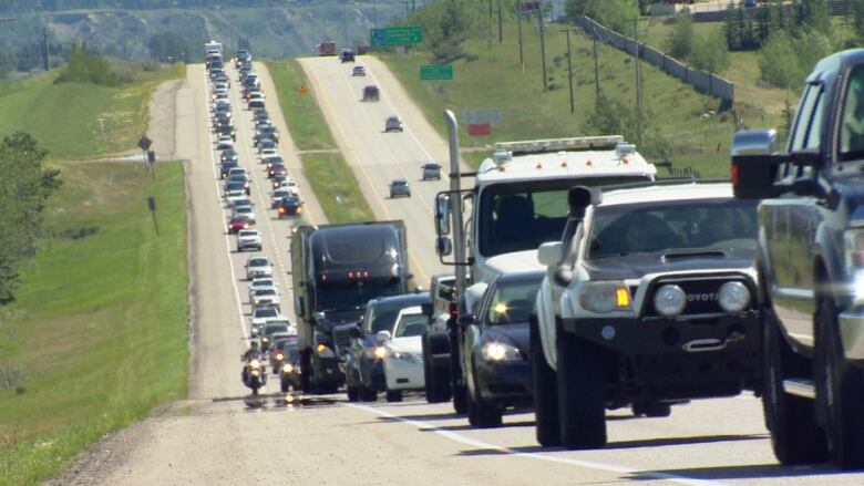 Dozens of vehicles seen in bumper to bumper traffic on the highway.