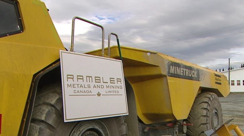 A big yellow dump truck with Rambler mines logos on the side.