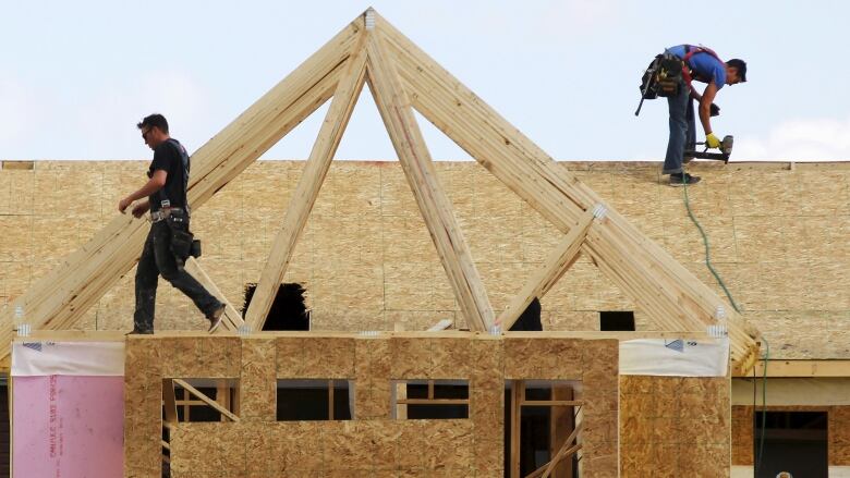 Construction workers build a new house