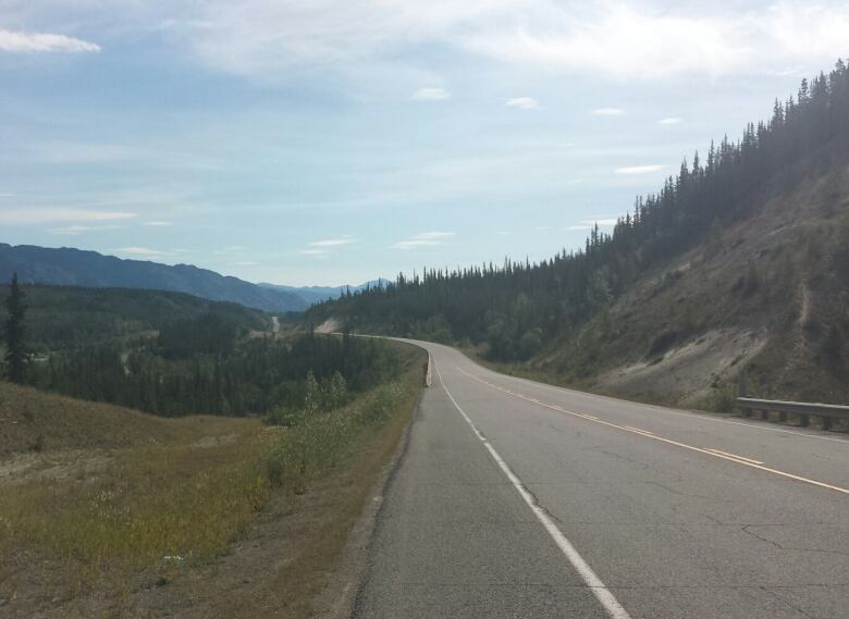 A view of an empty highway through the mountains.