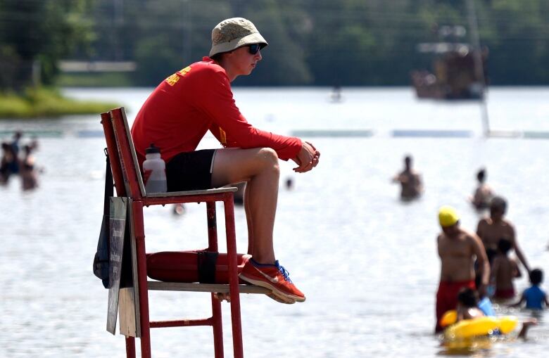 Aa lifeguard keeps an eye on swimmers at a city beach.