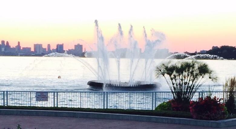 A picture of a fountain at sunset