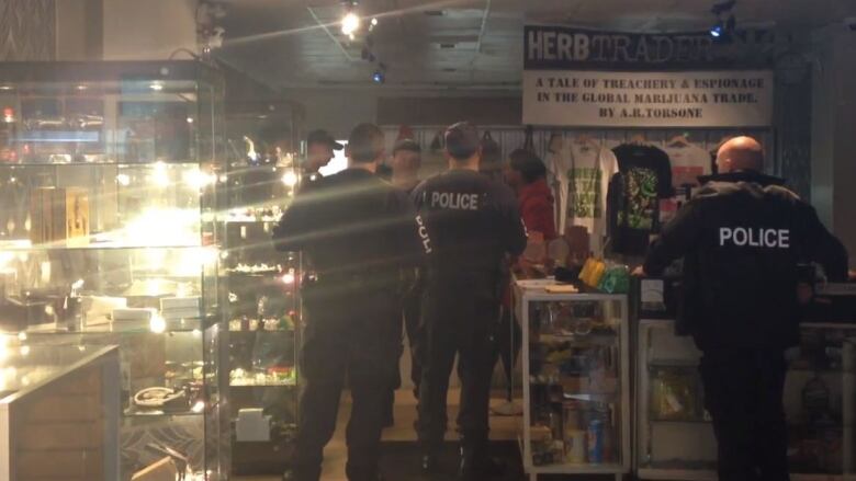 Police officers are shown inside a business.