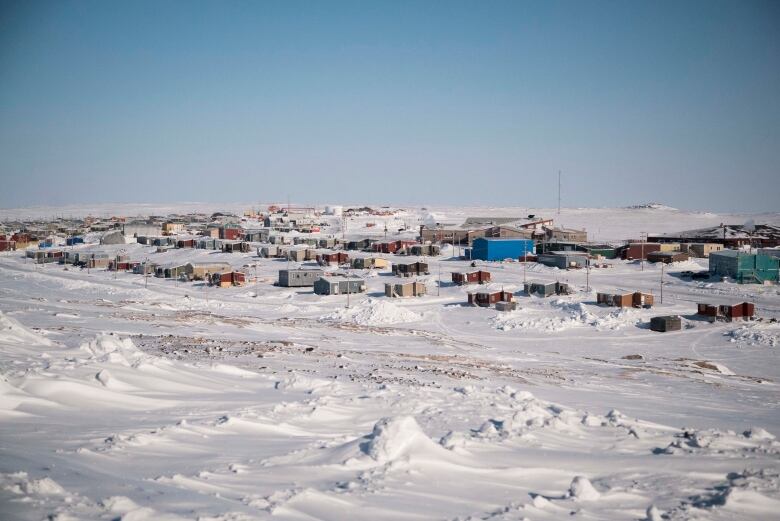 Buildings on snowy landscape.