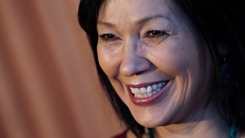 Close up of a smiling woman with dark hair 