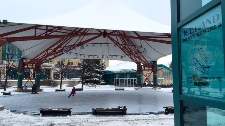 A skating rink is shown beneath a canopy.