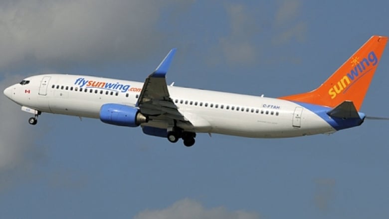 Sunwing plan flying in the sky. 