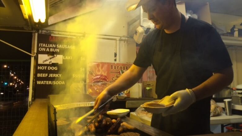 man grilling a burger