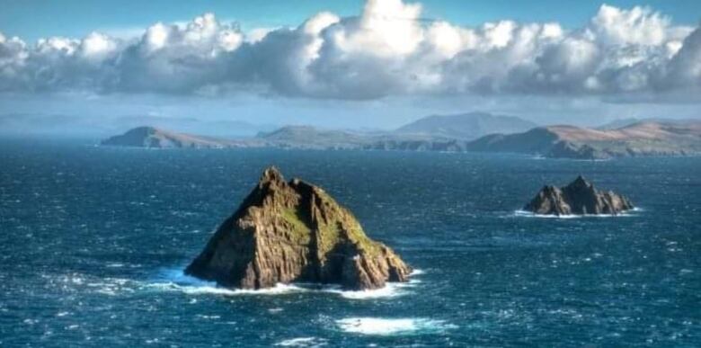 photo of rocky island surrounded by the ocean