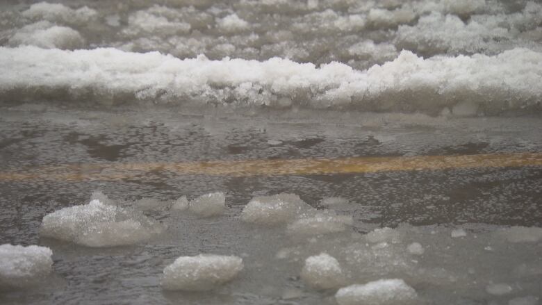 Water and snow mixed together on a roadway.