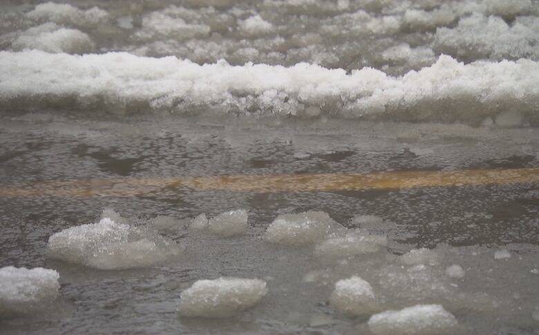 Water and snow mixed together on a roadway.