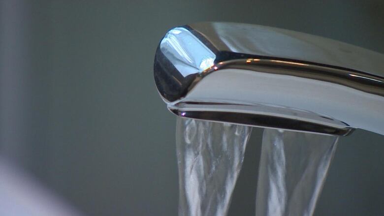 Photo of a chrome tap with water running out of it. 