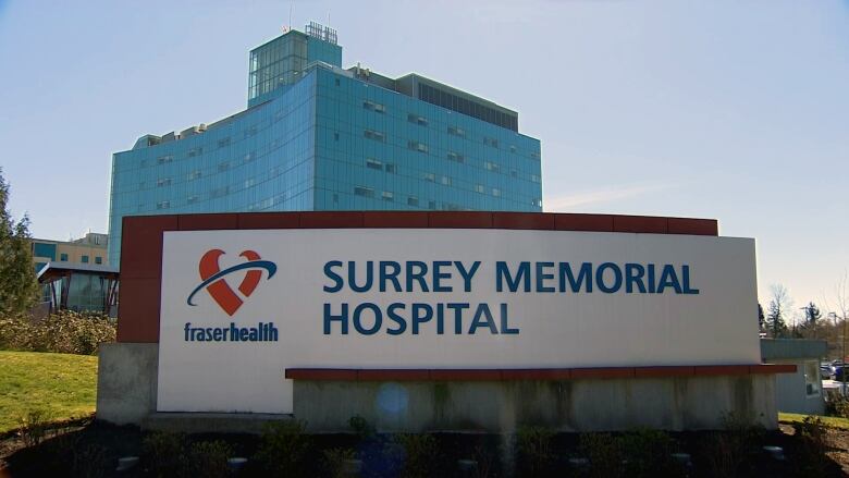 Hospital is pictured behind a sign that says Surrey memorial Hospital.