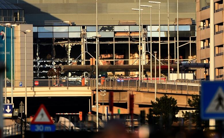 Broken windows are seen at the scene of explosions at an airport.