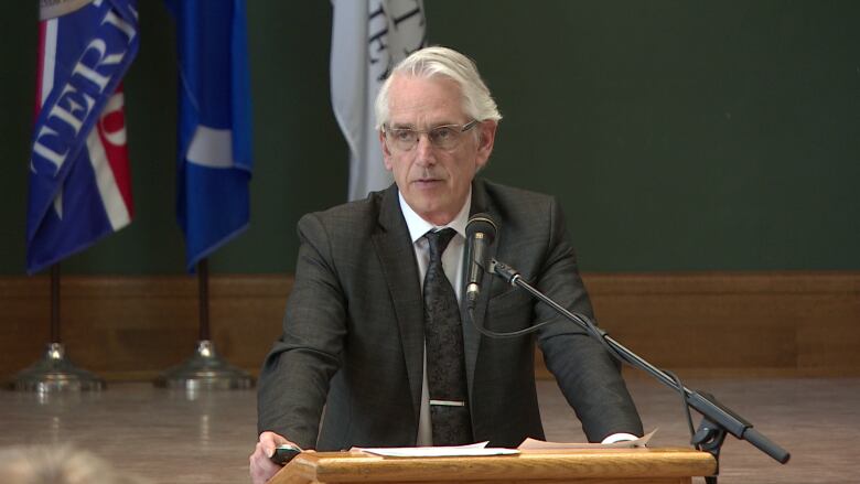 Man speaking at a podium