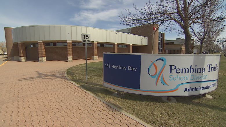 Exterior of a building with a sign on the front lawn that says Pembina Trails School Division