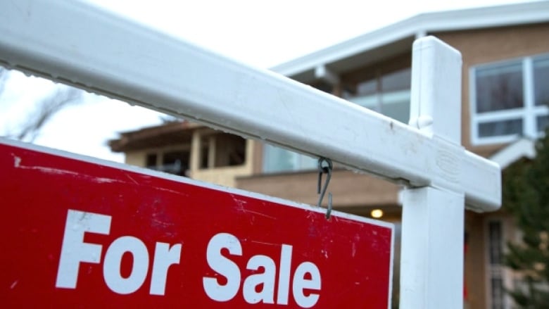 A large for sale sign in front of a home.