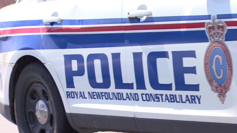 The side of a police car with the words Royal Newfoundland Constabulary marked on it.